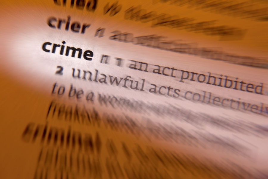 Image of blurred dictionary page with the word crime highlighted.