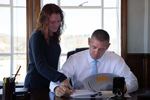 Asheville Criminal Defense Lawyer, Thomas Amburgey, with Paralegal, Vanessa Sprouse, working on a client file at Thomas's downtown office